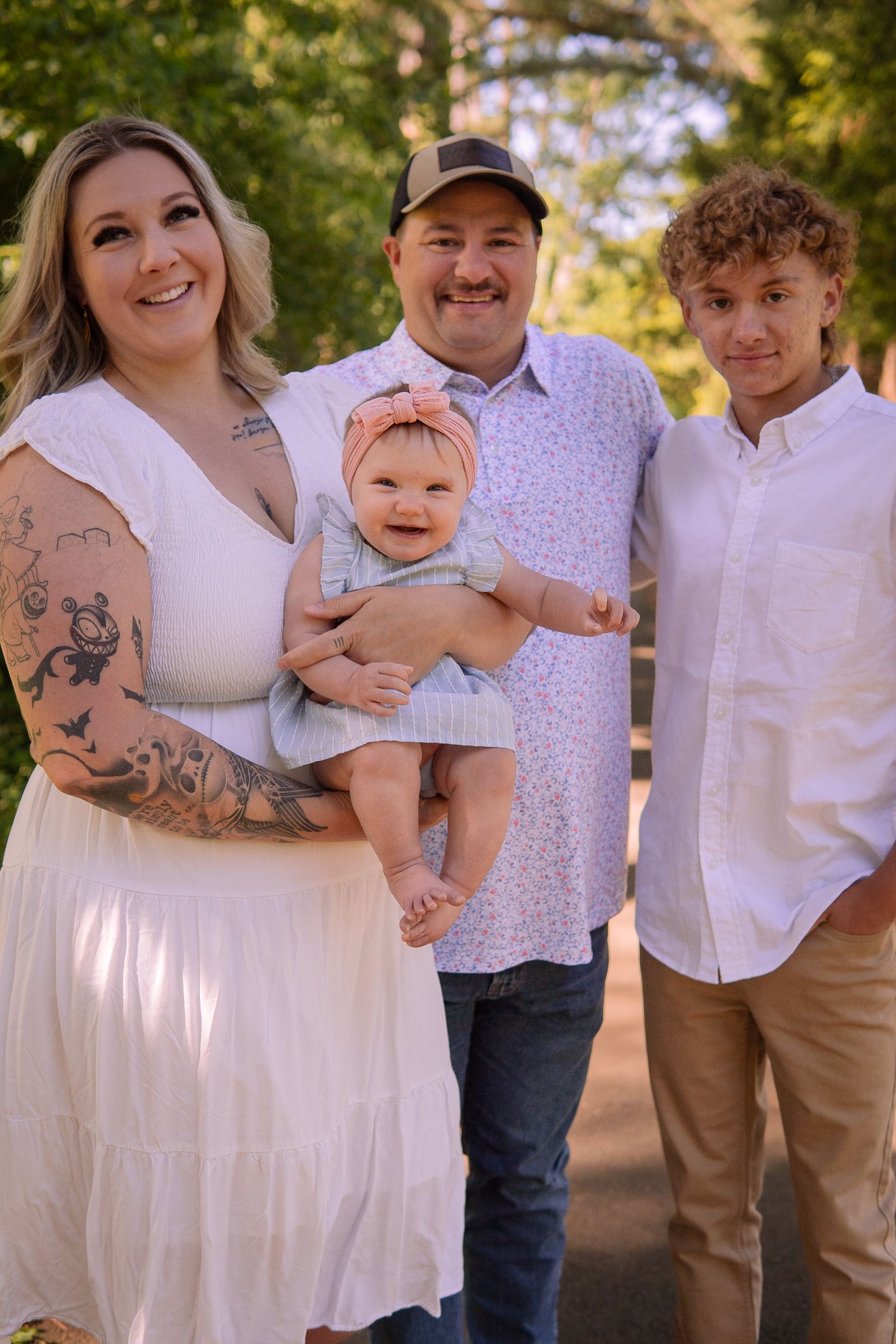 Family portrait series showing casual group interactions outdoors in coordinated white outfits.