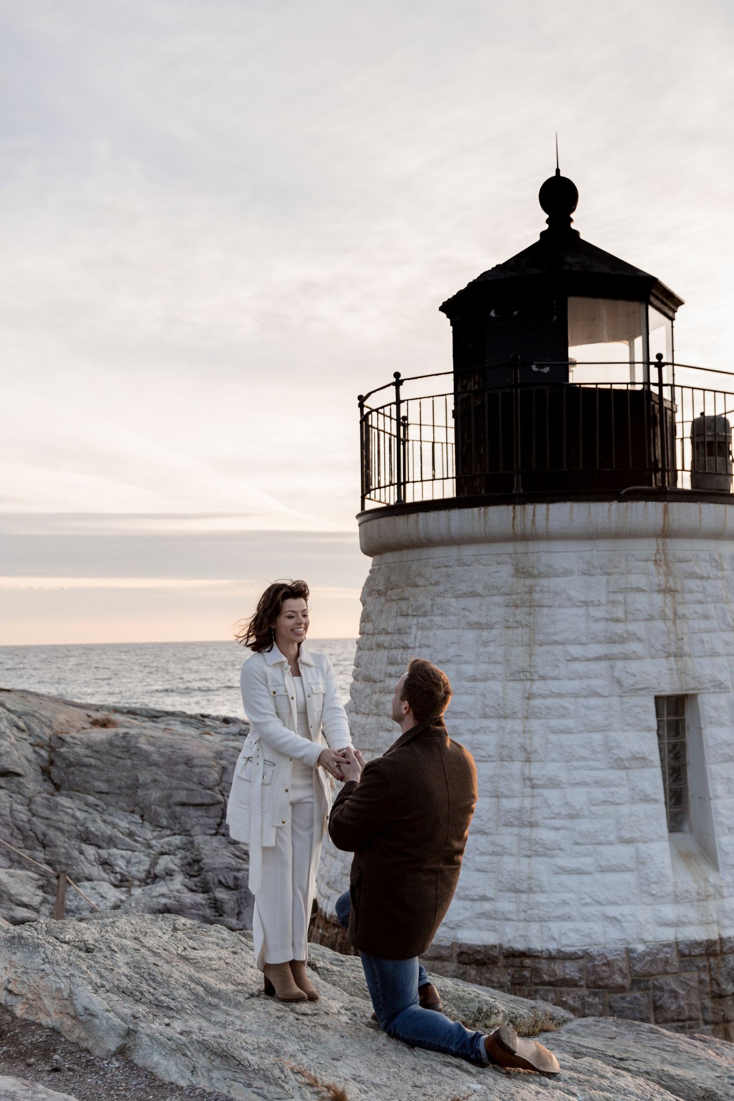 A romantic proposal takes place at sunset by the Castle Hill lighthouse in Newport, Rhode Island.