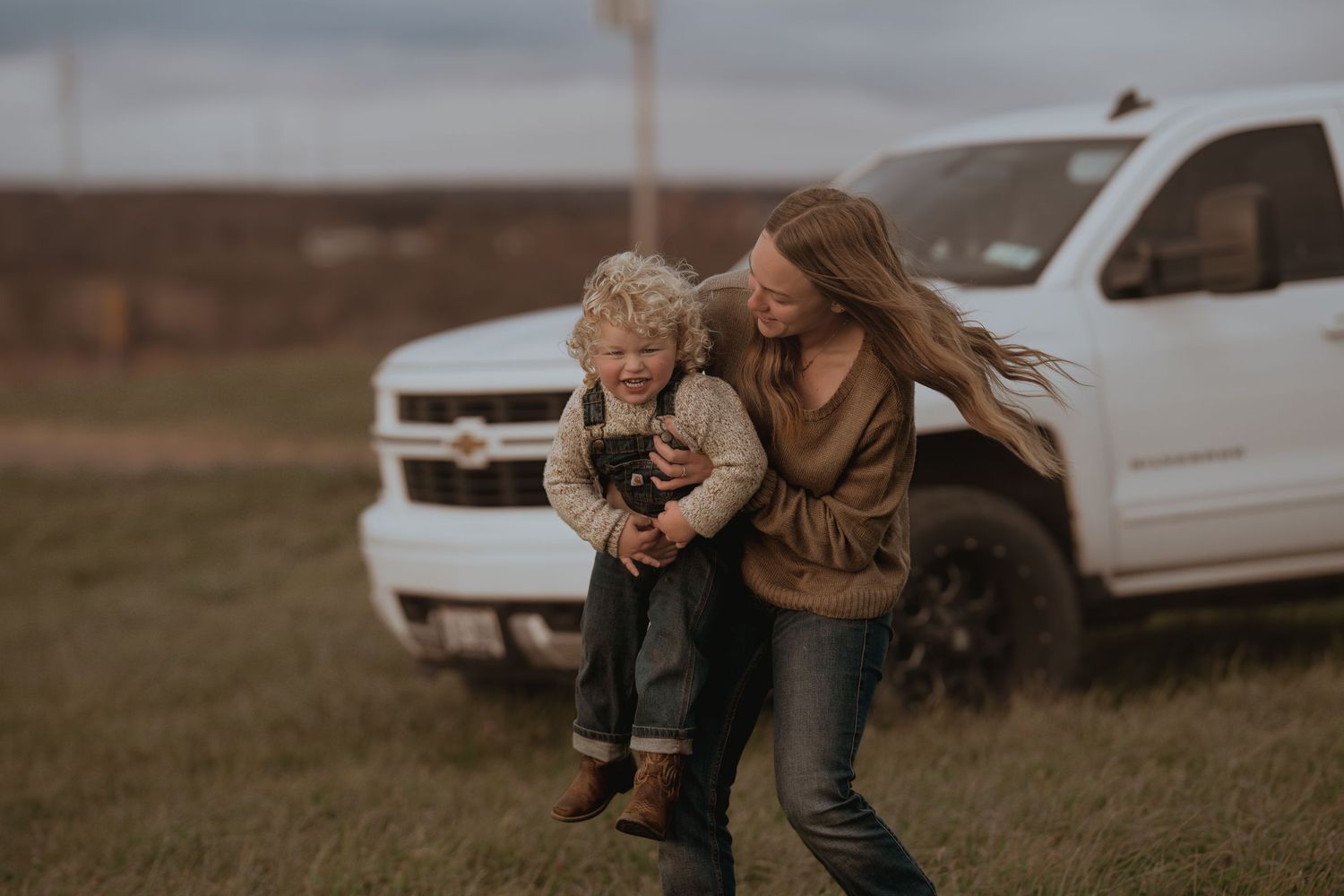 White truck serves as backdrop for an afternoon of outdoor play.