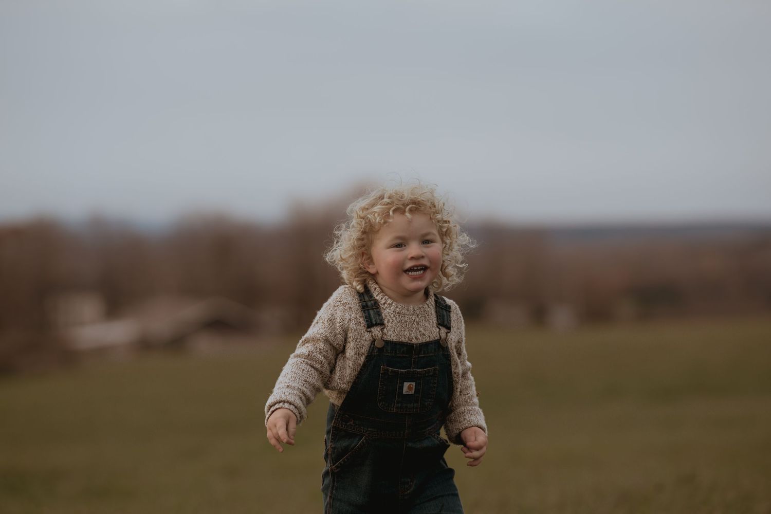 Joyful laughter echoes across an autumn field during playtime.