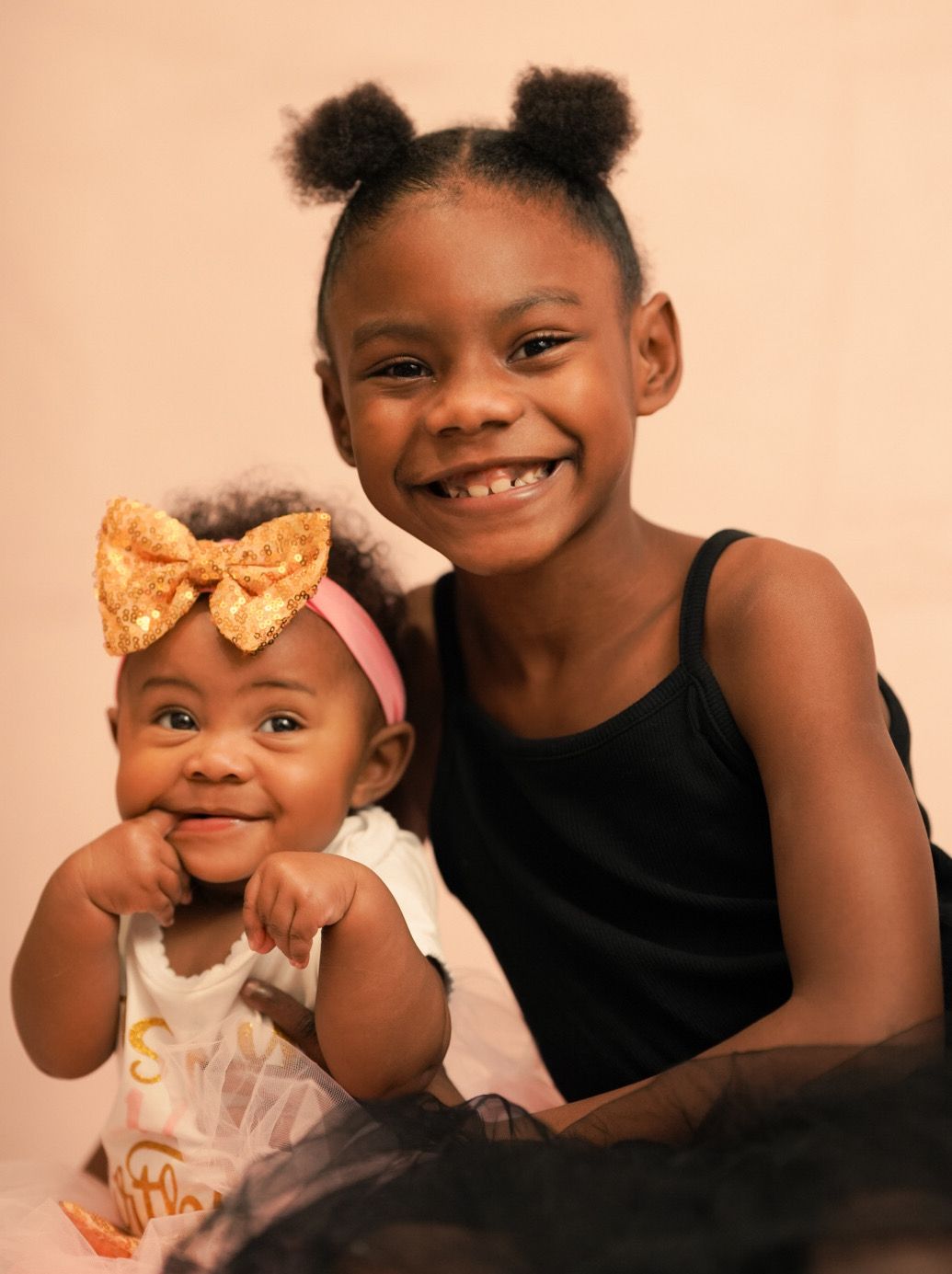 Heartwarming studio portraits capturing sweet interactions between siblings.
