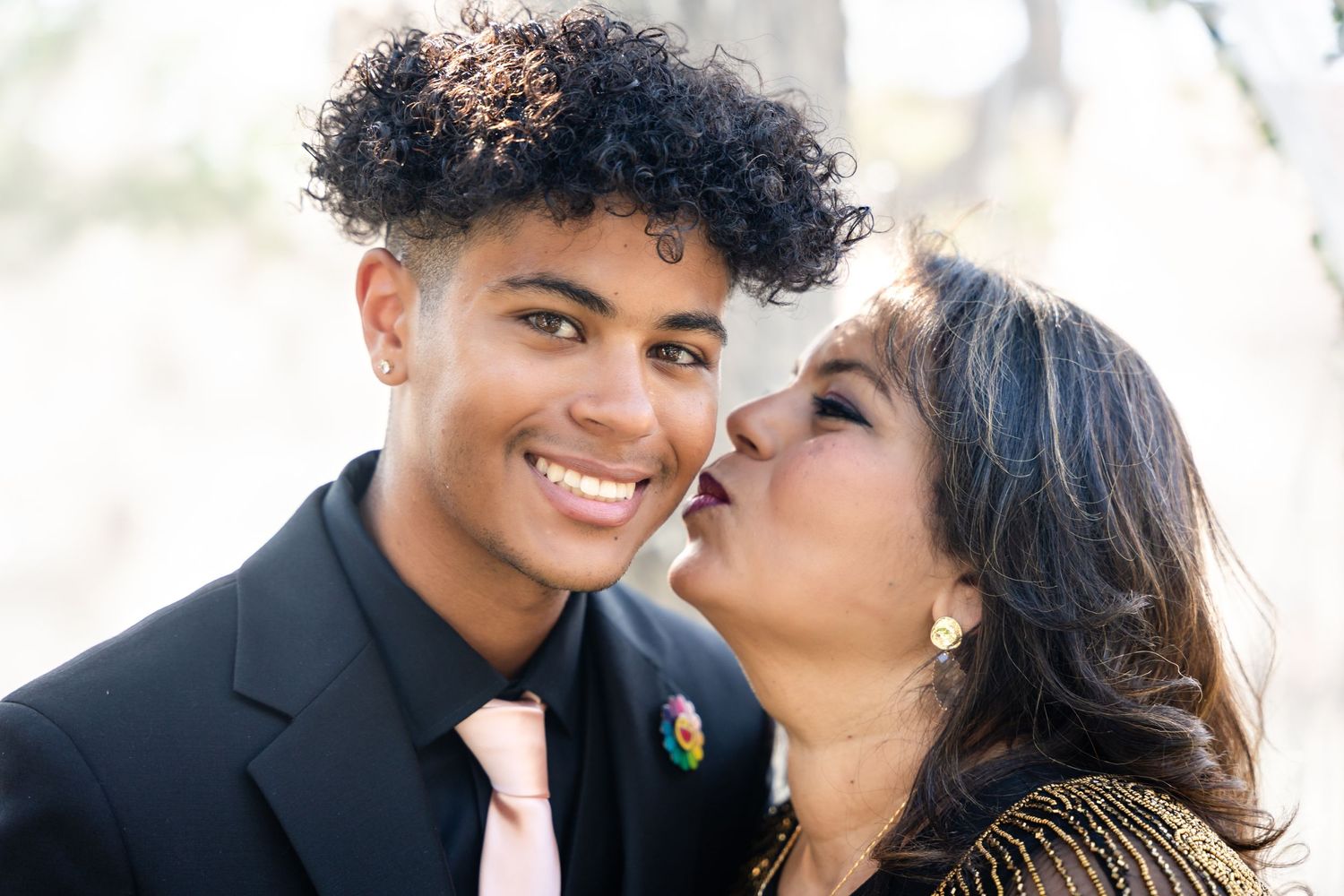 A tender moment captured between two people at an outdoor wedding.