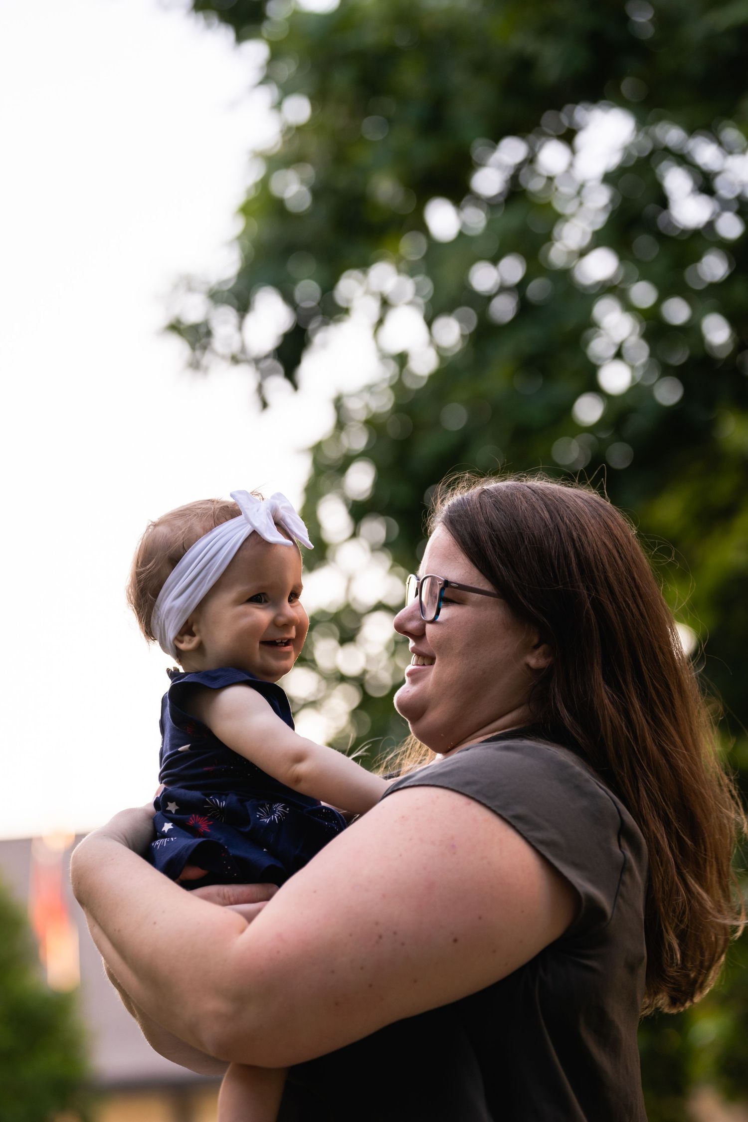A tender moment between parent and child outdoors in natural lighting.