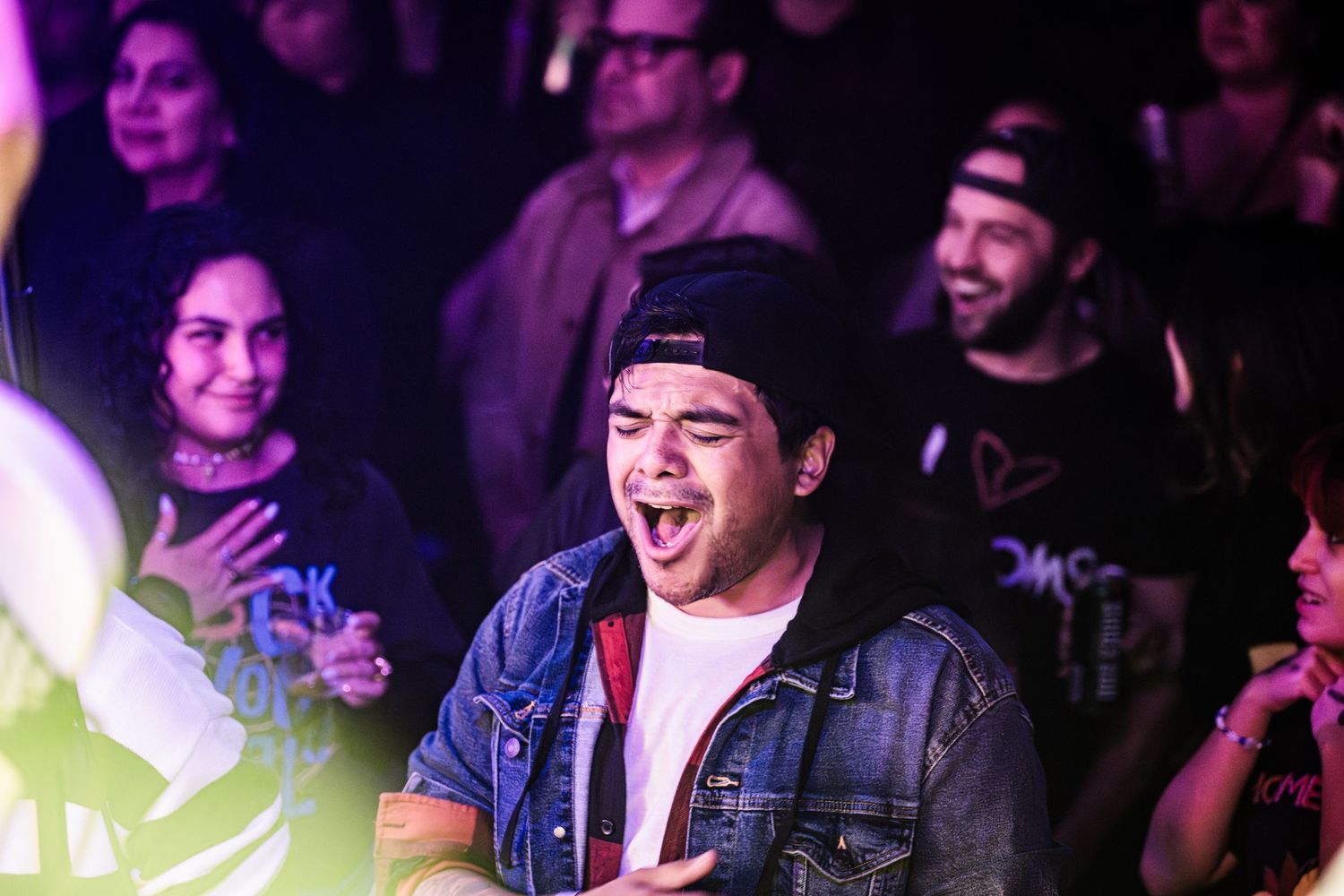 Concert attendee showing excitement and joy during live performance.