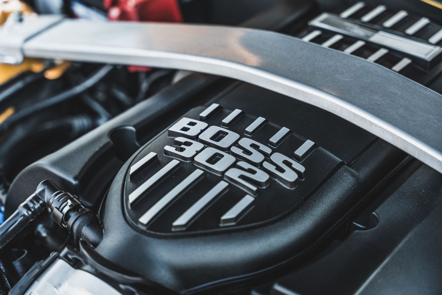 Close up of a Boss 302 engine cover in a Ford Mustang engine bay.