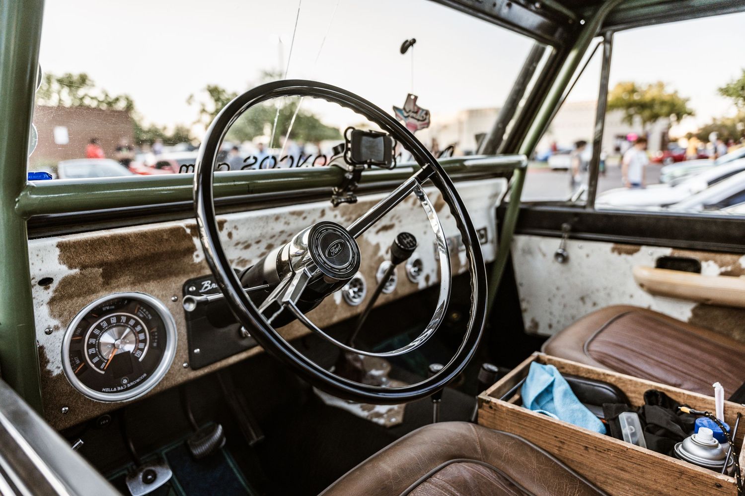 Classic vintage car interior showing retro steering wheel and dashboard.