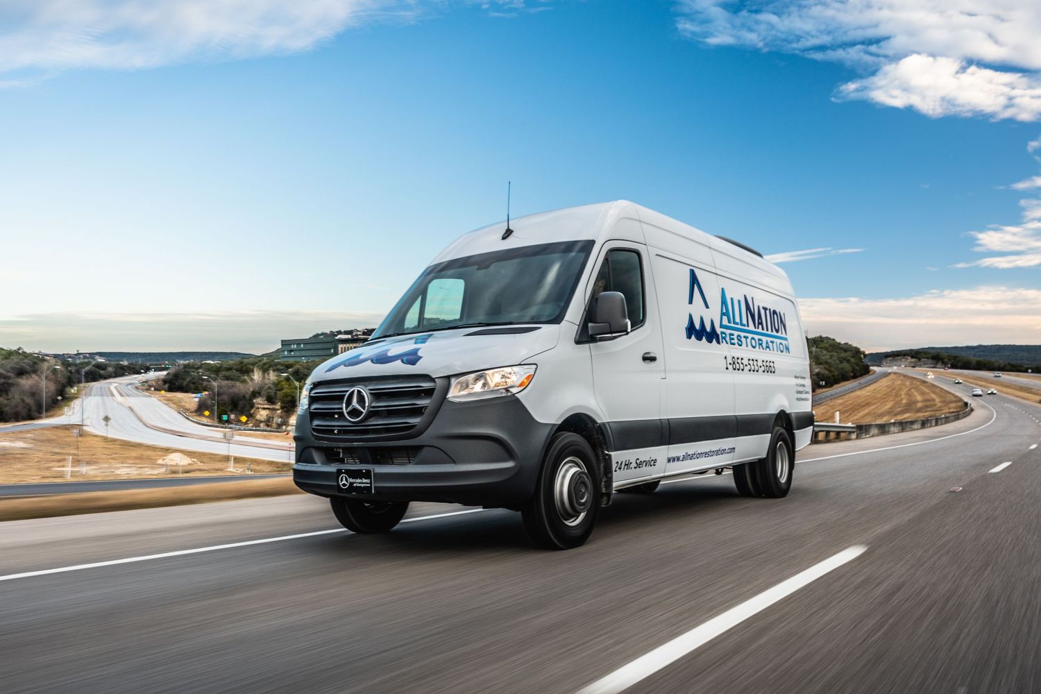 A Mercedes-Benz delivery van with Modern Age Health Care branding drives on a winding mountain road.