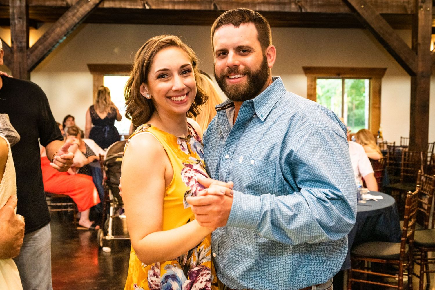 A couple shares a dance moment at their rustic-themed wedding reception.