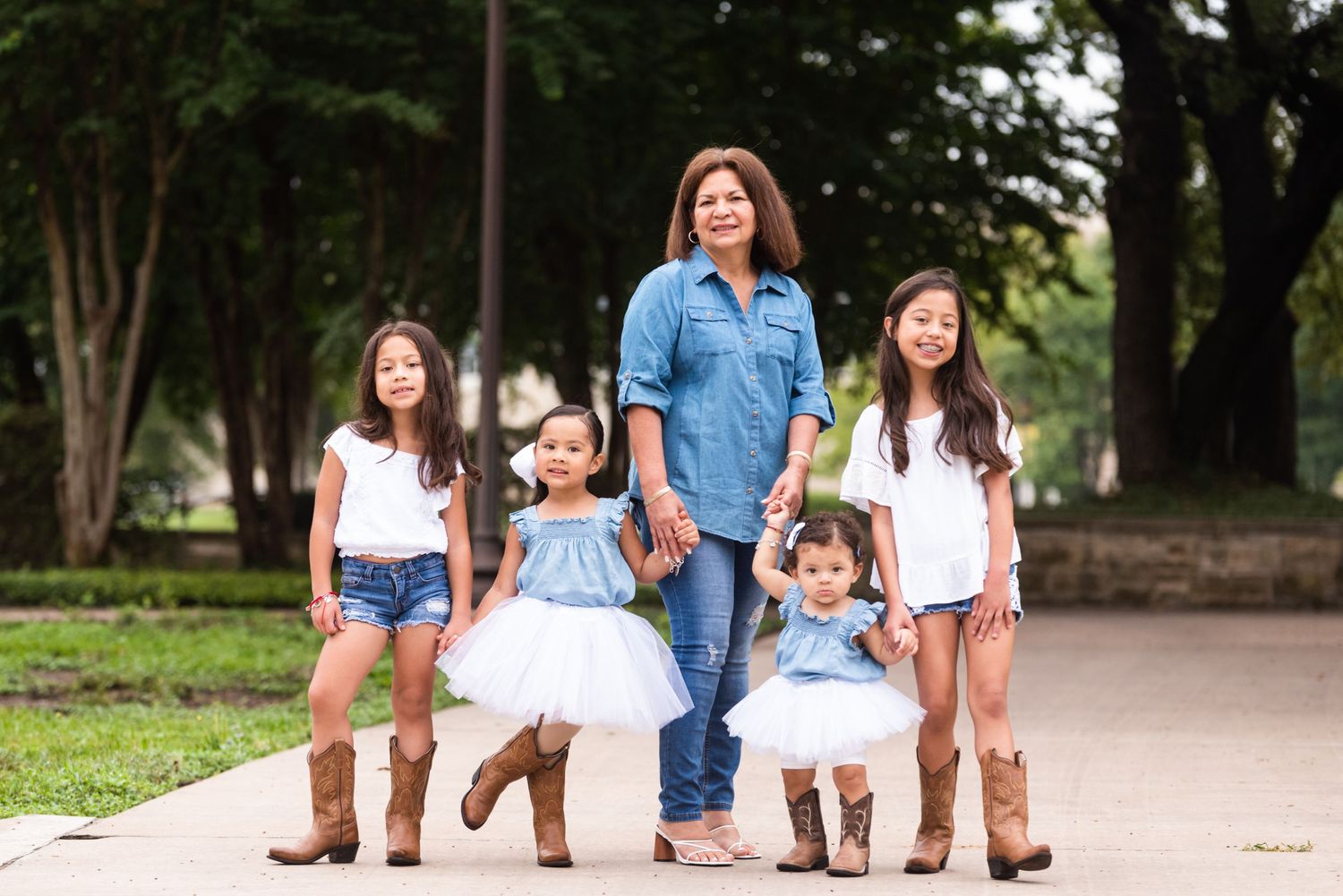 A family group walks together outdoors wearing matching casual outfits.