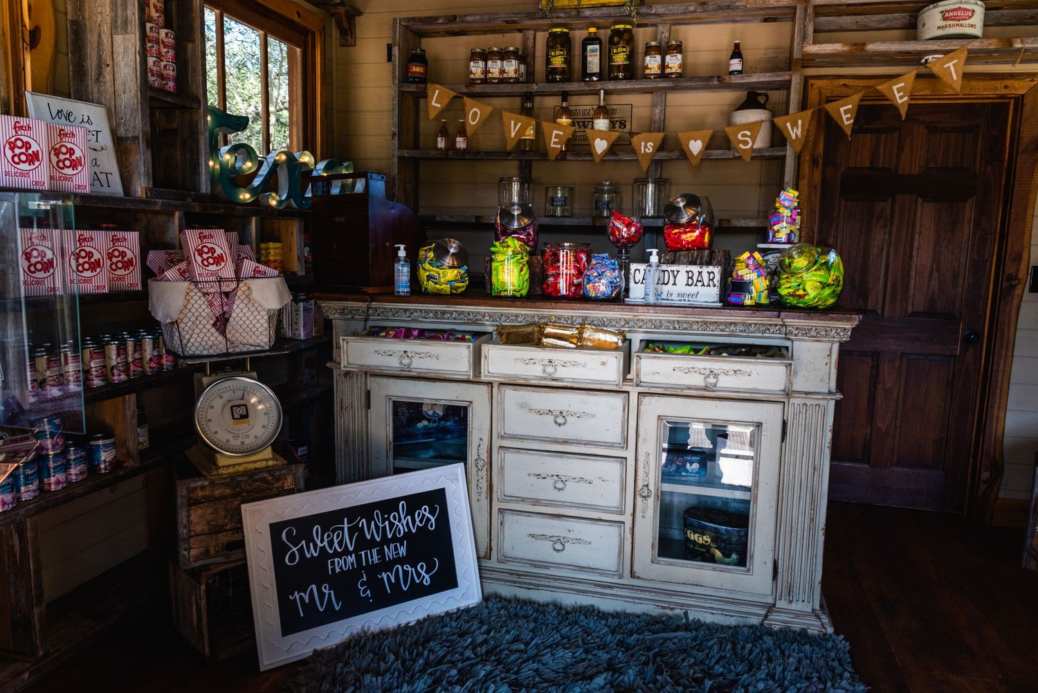 Rustic bar setup with vintage cabinets and cocktail mixers at wedding venue.