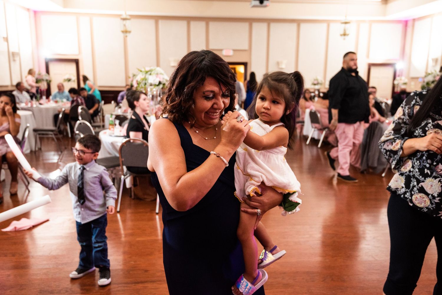 A joyful celebration with dancing and laughter at an indoor event venue.