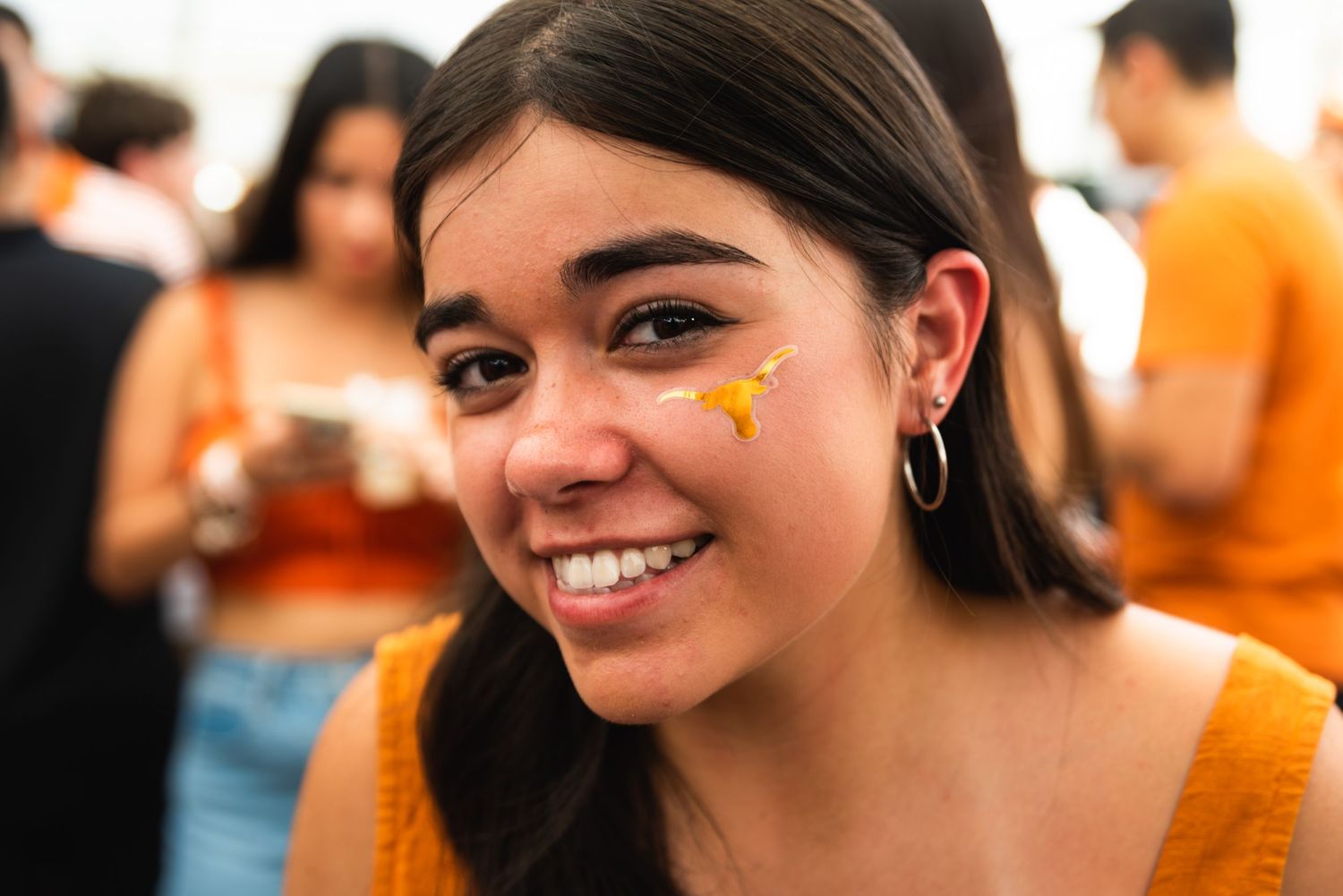 A series of photos showing someone wearing orange star stickers on their face while smiling warmly at the camera.