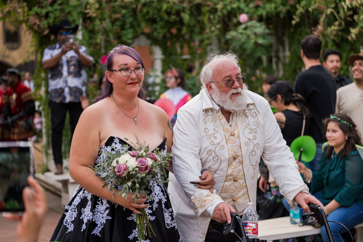 Couples dancing together at an outdoor social event in a garden setting.