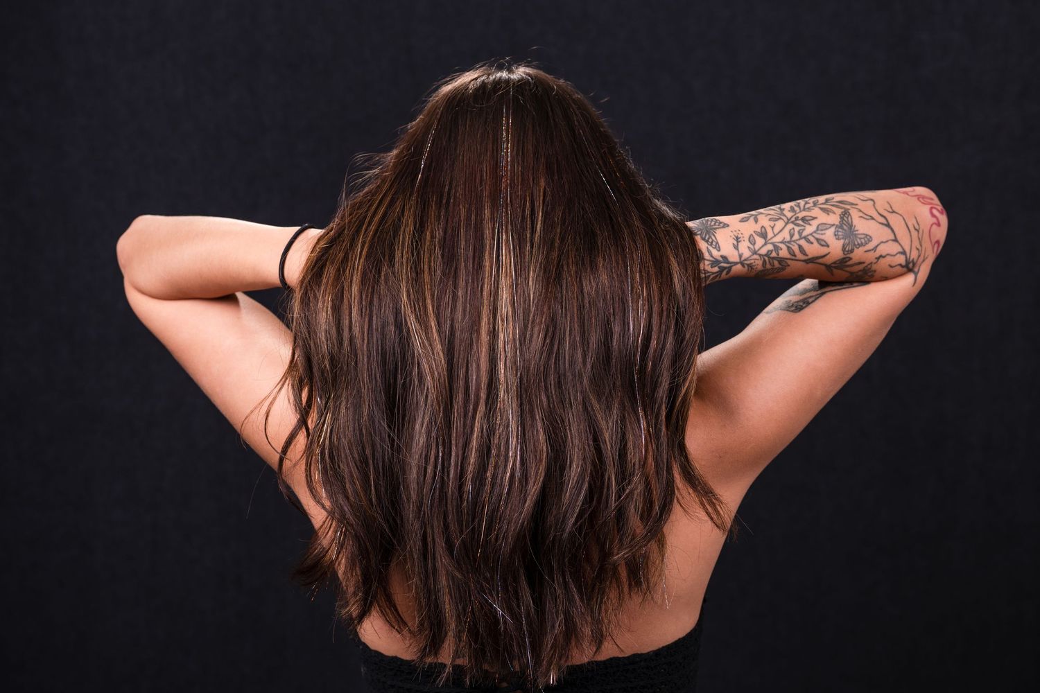A series of artistic black and white photographs showing different angles and poses of a person with long dark hair.
