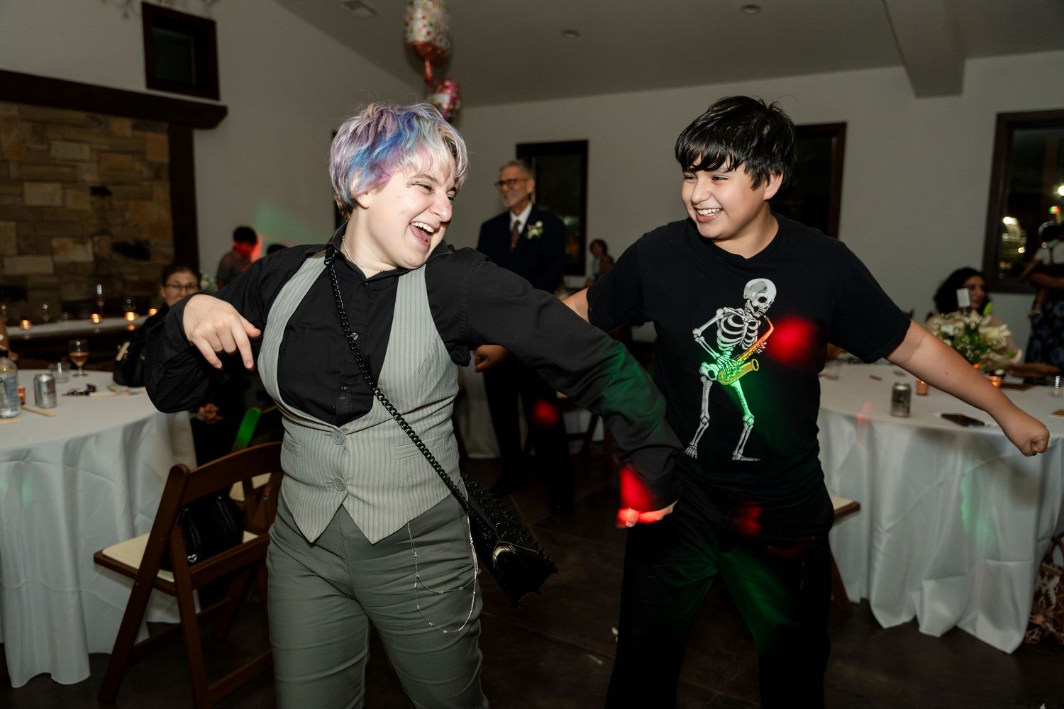 Energetic dance party scene with people having fun on a dance floor under dim lighting and red accents.