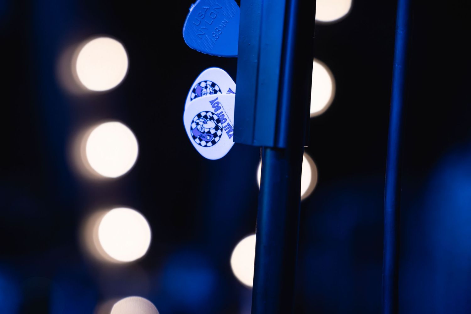 Close-up of stage lighting equipment with bokeh effect in blue tones.
