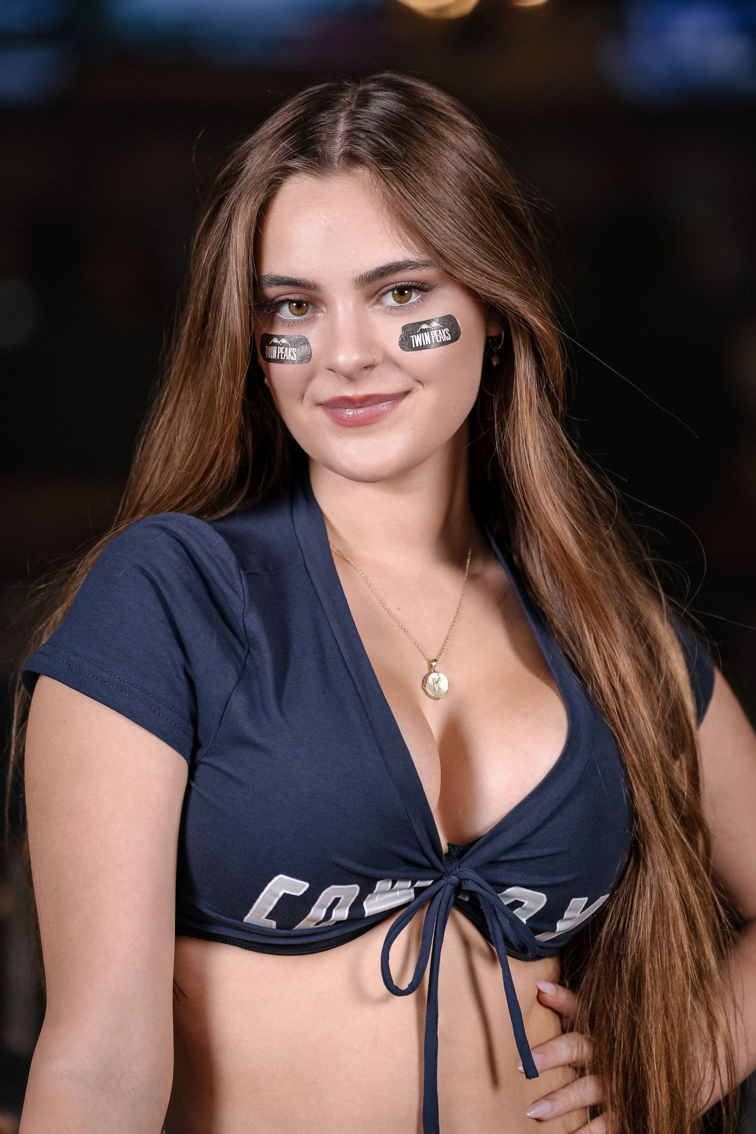 Sports bar promotional photo with eye black strips and navy athletic wear.