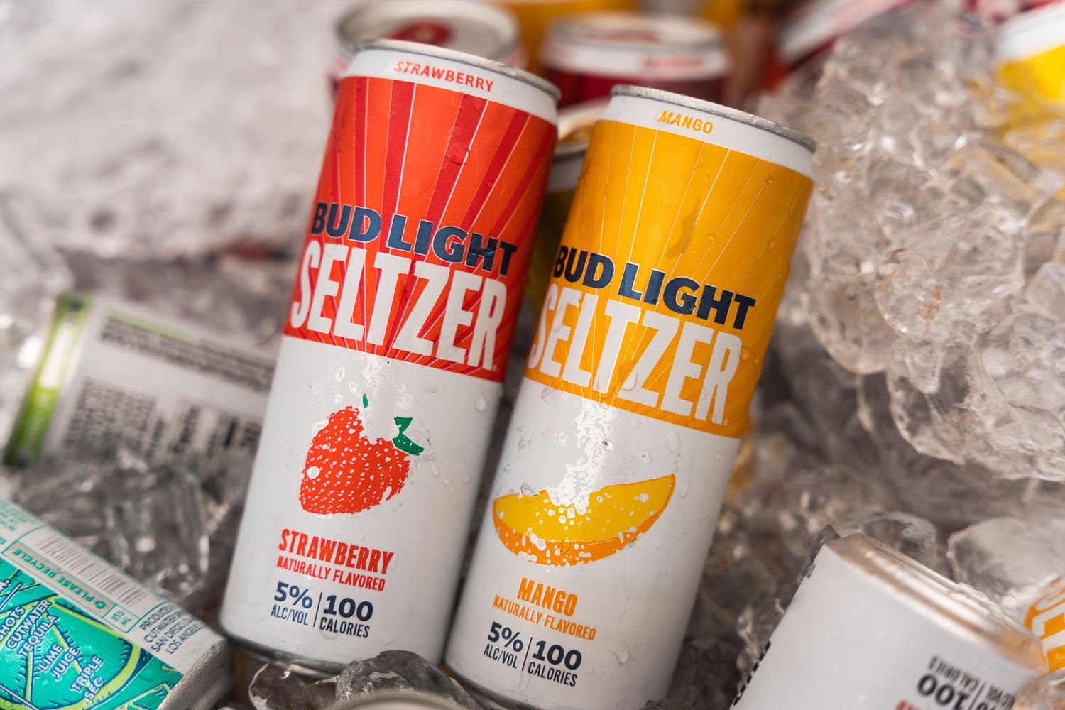 Strawberry and mango flavored Bud Light Seltzer cans on ice.