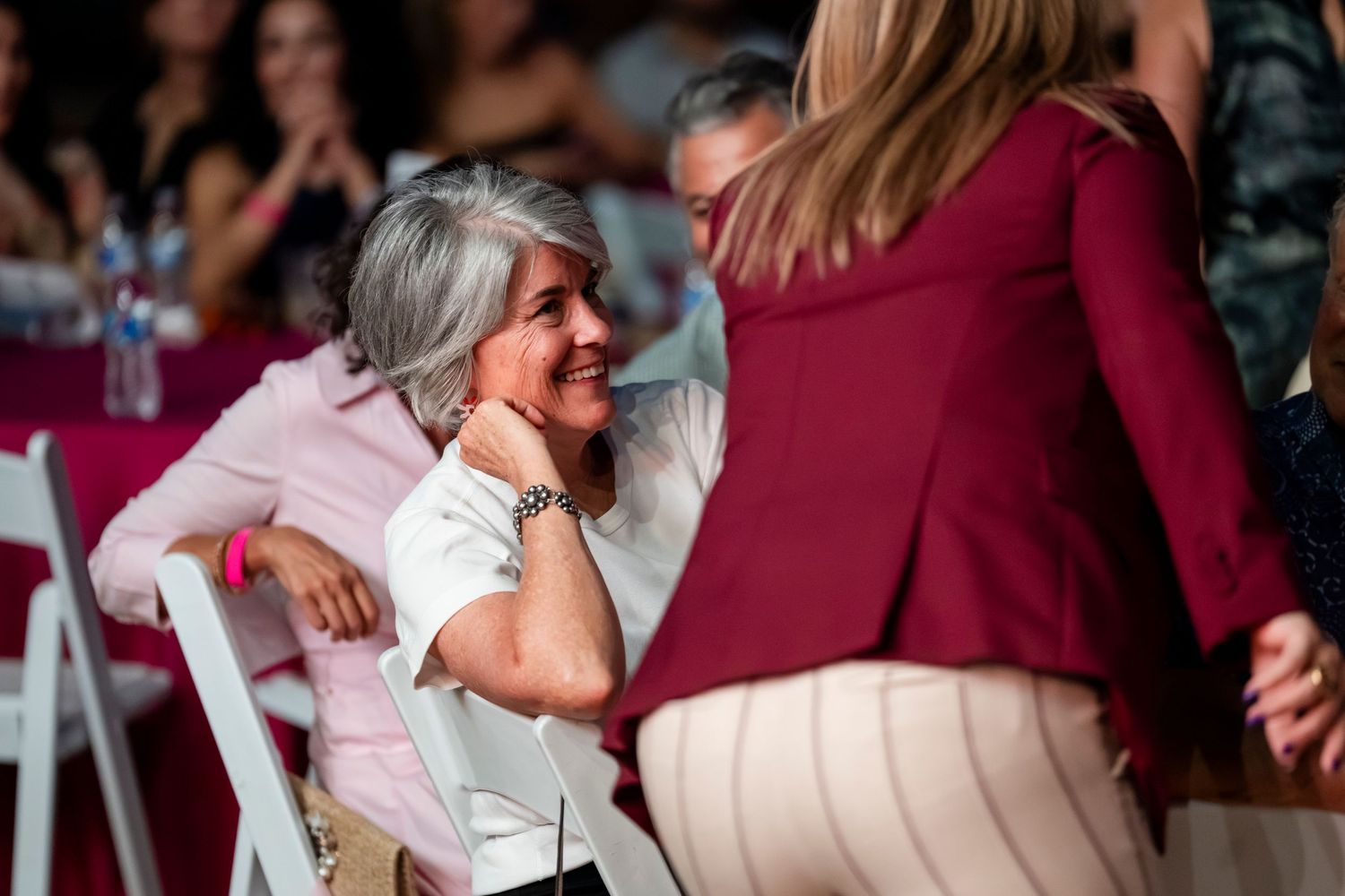 A series of six candid photos showing people embracing and celebrating at what appears to be a wedding reception.