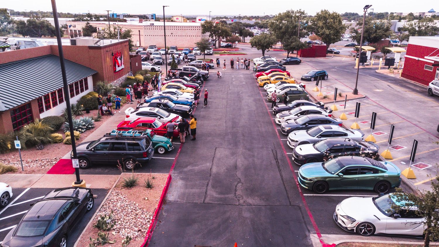 Overhead drone shot of car meet at Twin Peaks parking lot during sunset.