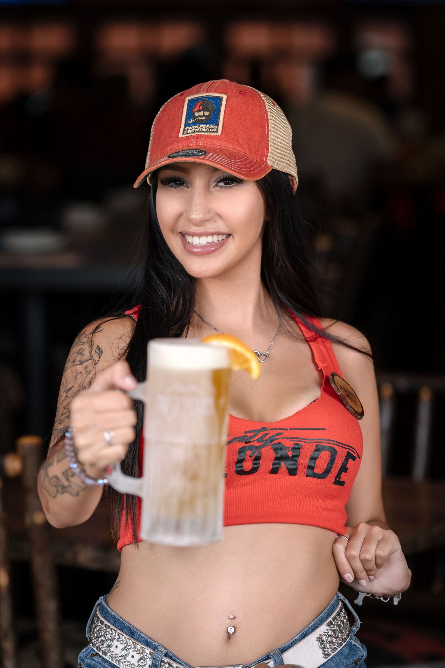 Indoor brewery photo featuring a beer and casual summer clothing.