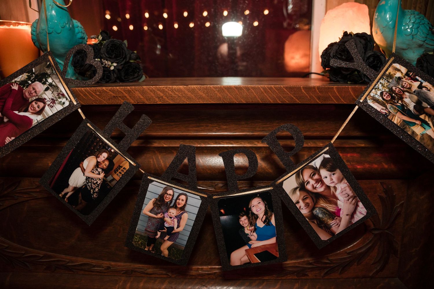 A decorative string of photos hangs against a dark wood backdrop with teal accents.
