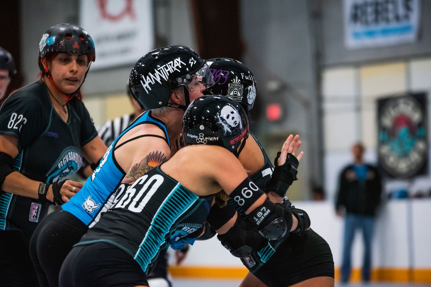 Two roller derby players collide during an intense match on the rink.