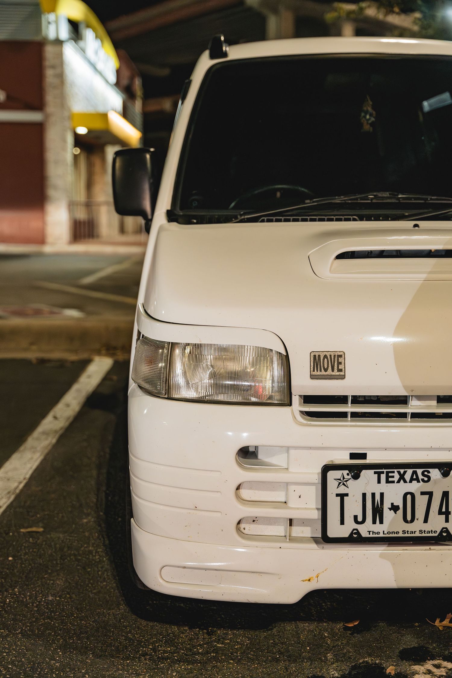 Front quarter view of white Honda Move kei car with Texas plates.