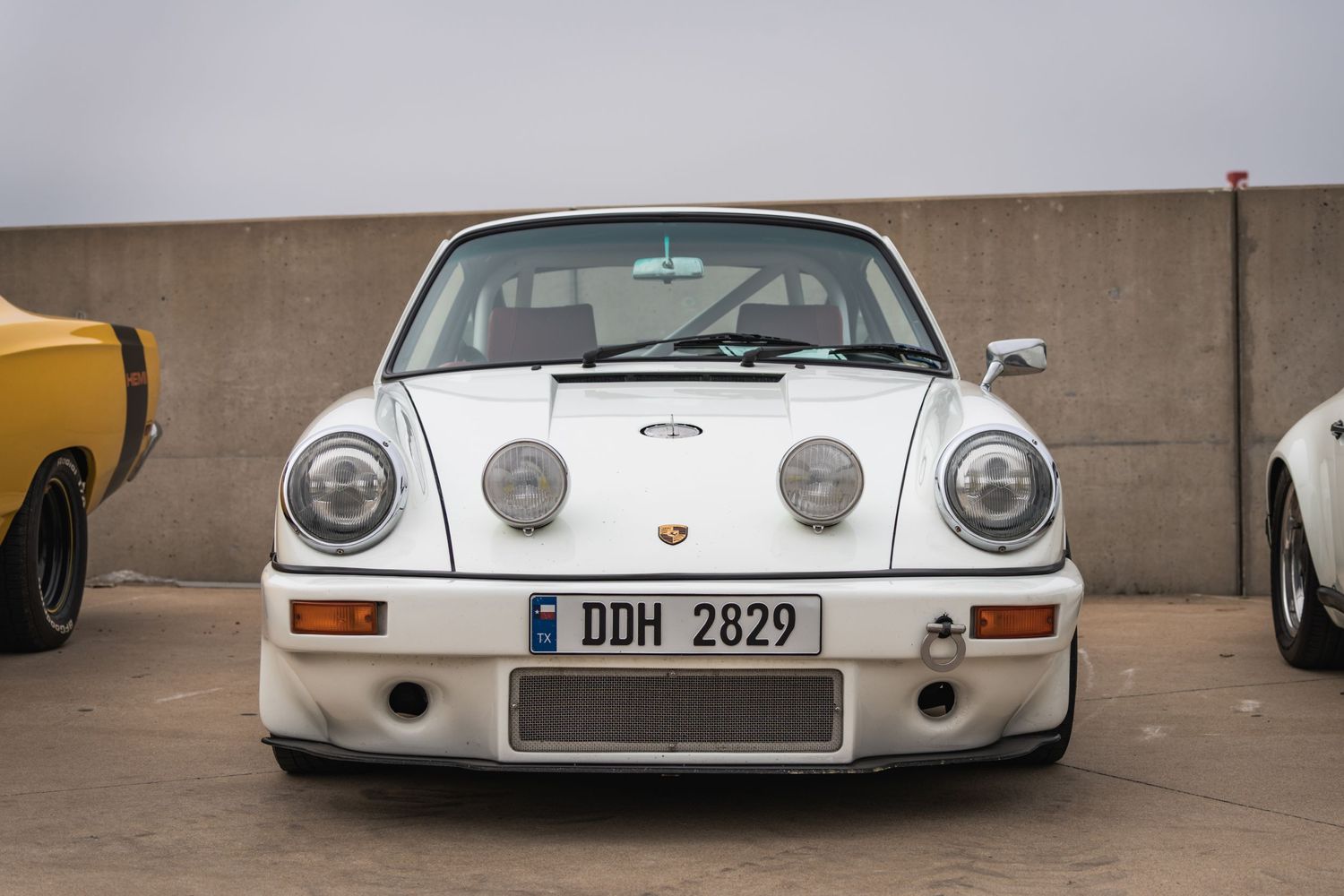 Front view of a classic white Porsche 911 RSR with distinctive racing modifications.