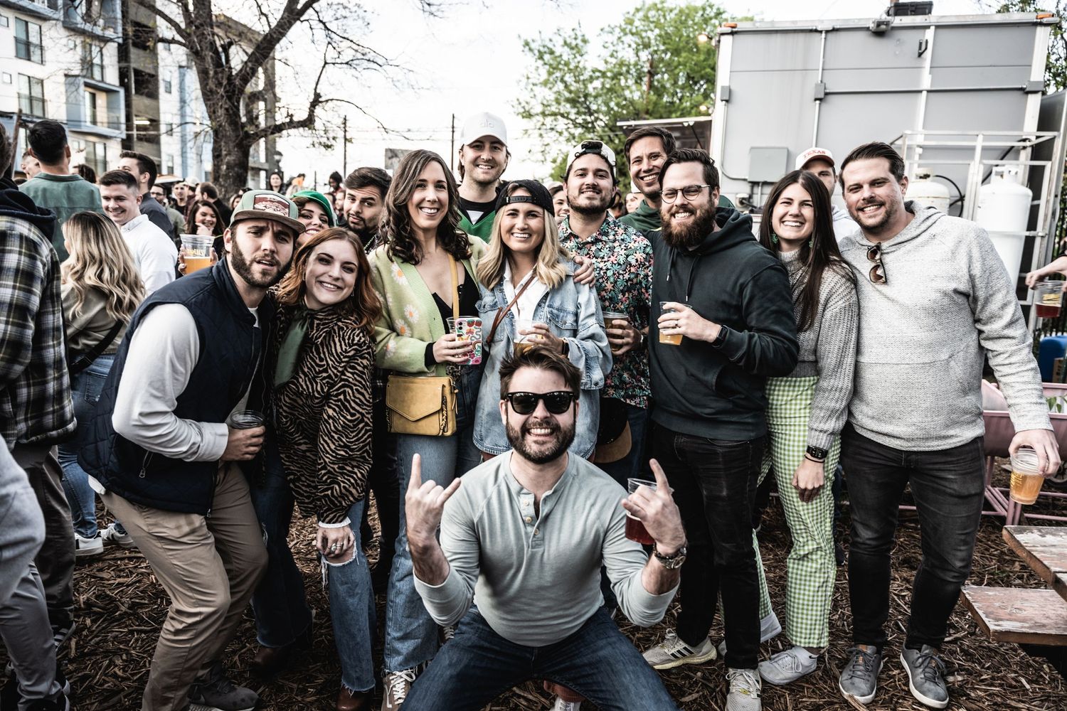 Group of festival attendees gathered outdoors for casual group photo.