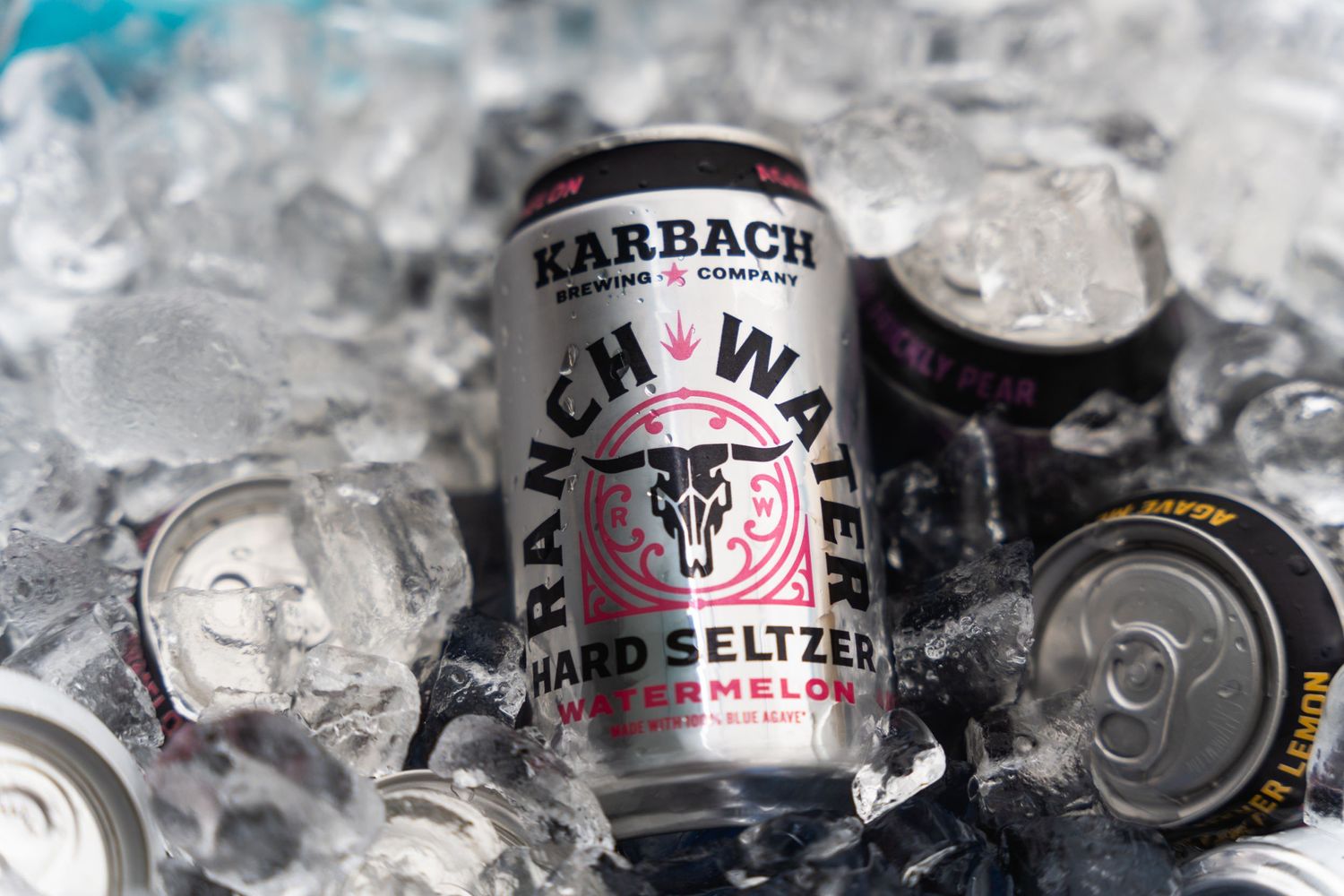 Multiple Karbach Ranch Water seltzer cans cooling in ice with condensation.