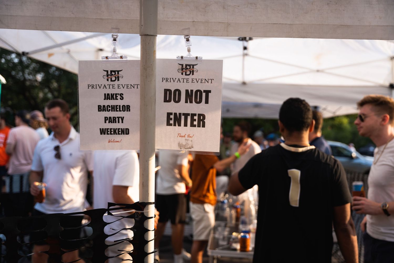 Do Not Enter signs hanging at private event with people walking in background.