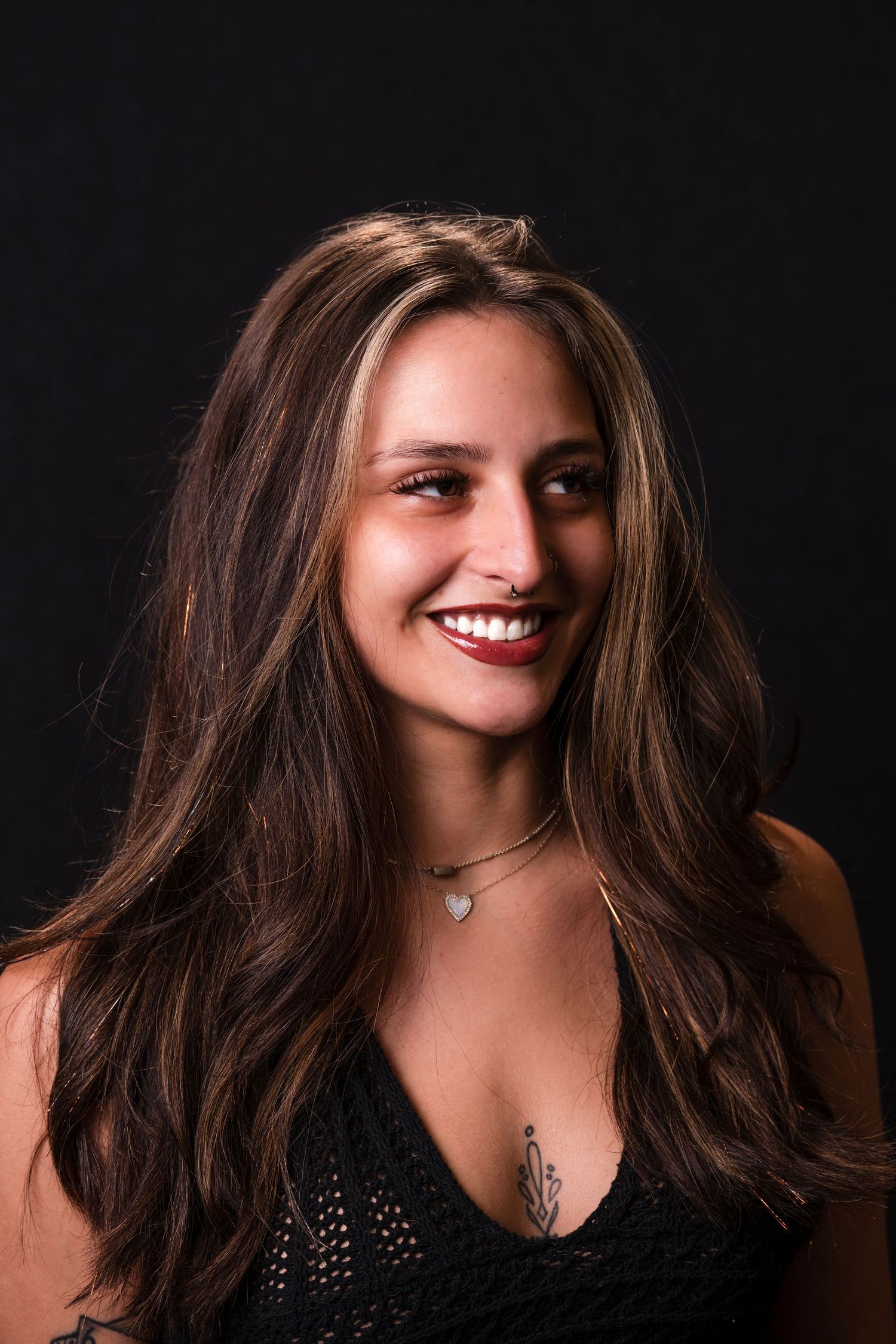 Portrait series showing dynamic expressions and movement of dark hair against black background in studio lighting.