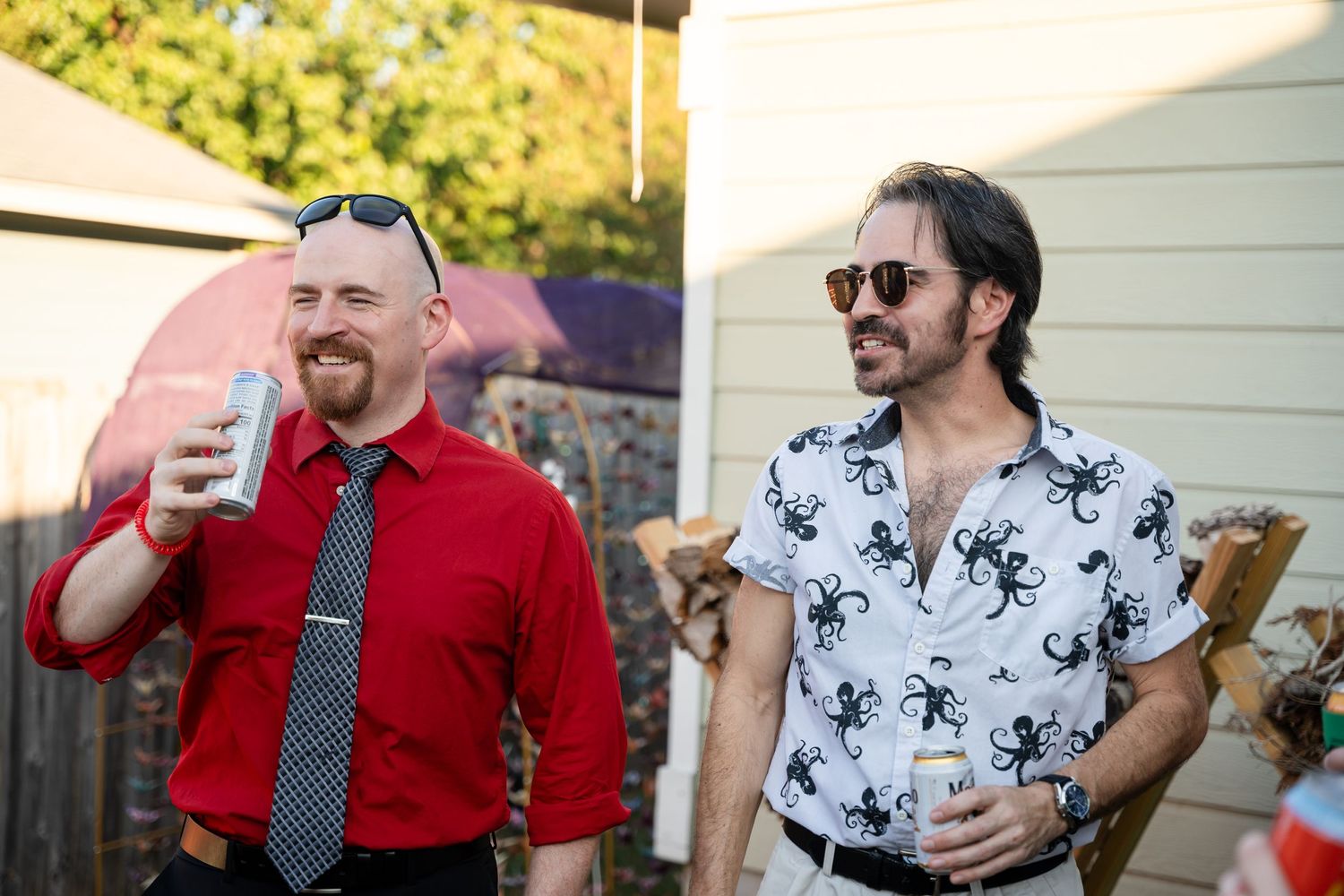 Two guests enjoying drinks at an outdoor gathering.