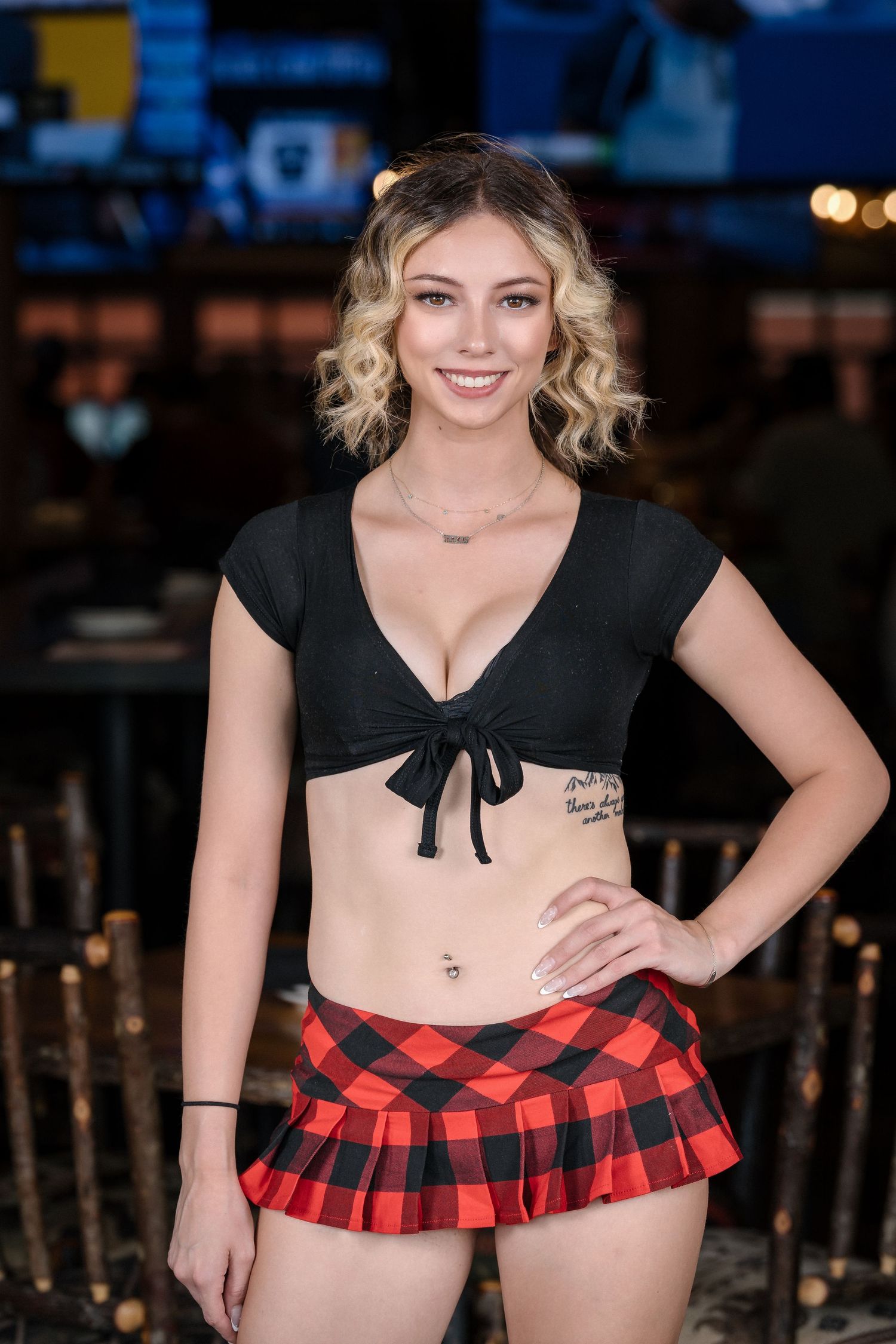 Restaurant server outfit with plaid skirt and black crop top.