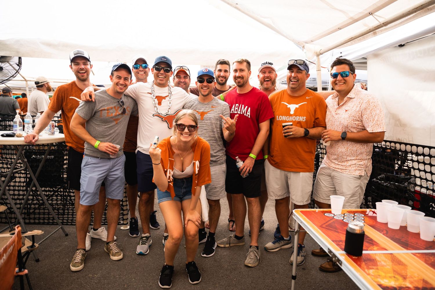 Friends gathered for a casual outdoor celebration wearing sports-themed attire.