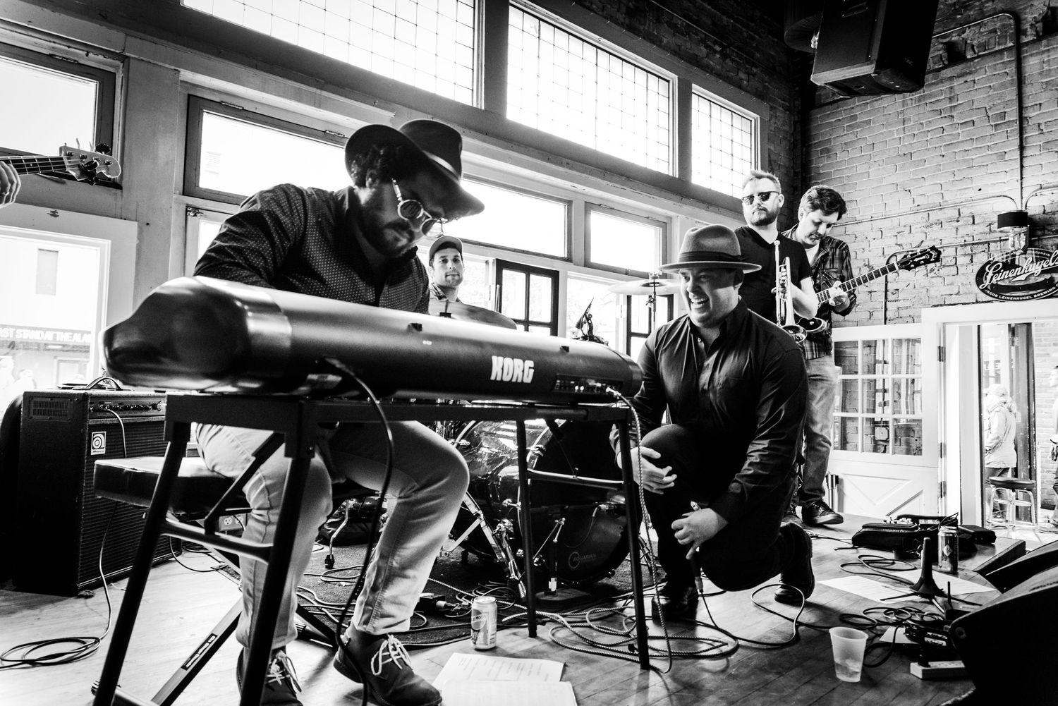 Black and white photo series showing musicians performing and recording in a studio setting.