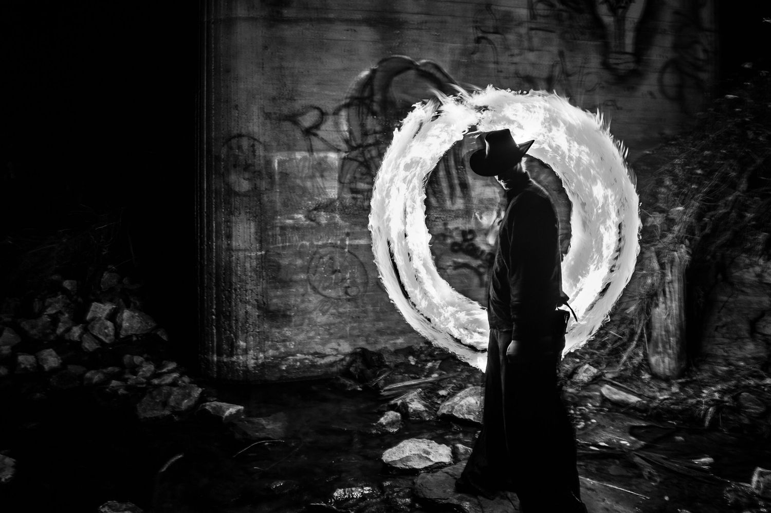A series of dark and moody black and white photographs arranged in a horizontal filmstrip-style layout.