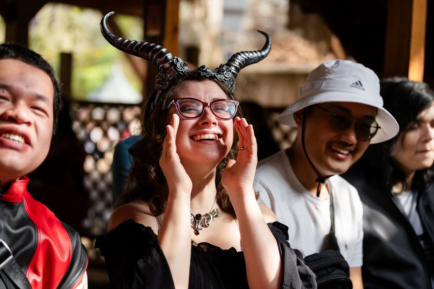 A crowd of spectators reacts with laughter and excitement at an outdoor event.