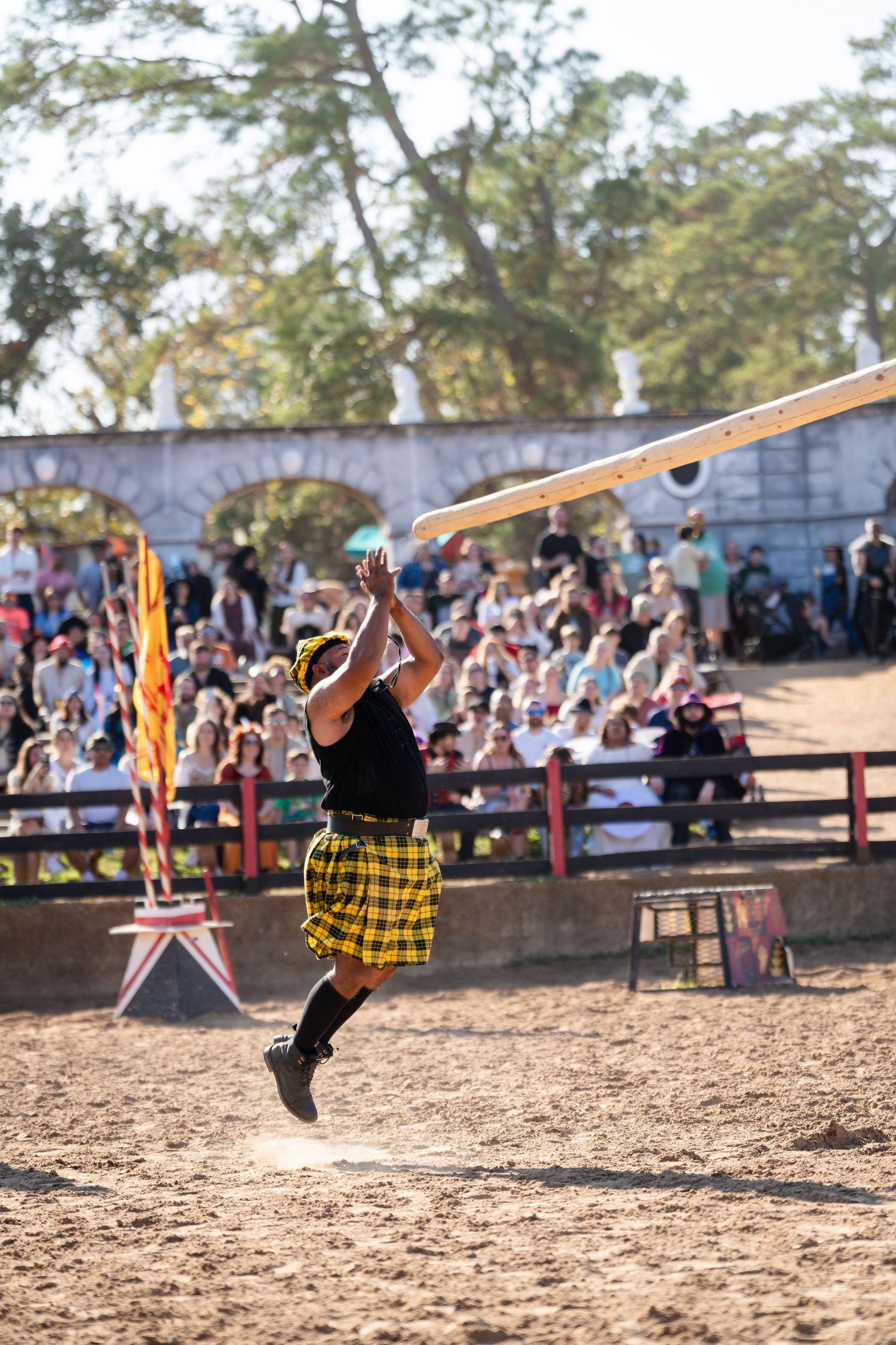 A sequence of photos showing a person performing a dynamic backflip maneuver in a dirt arena with spectators watching.