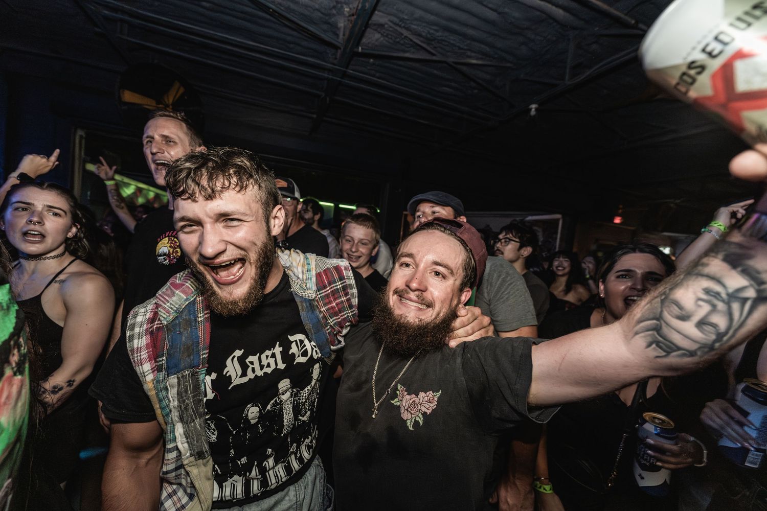 Animated concert goers celebrate during an intense live music performance.
