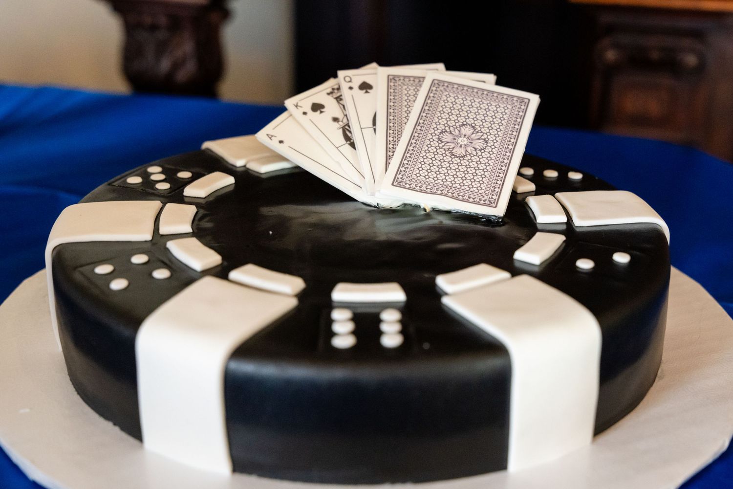 Black and white fondant cake designed like a poker game with playing cards on top.