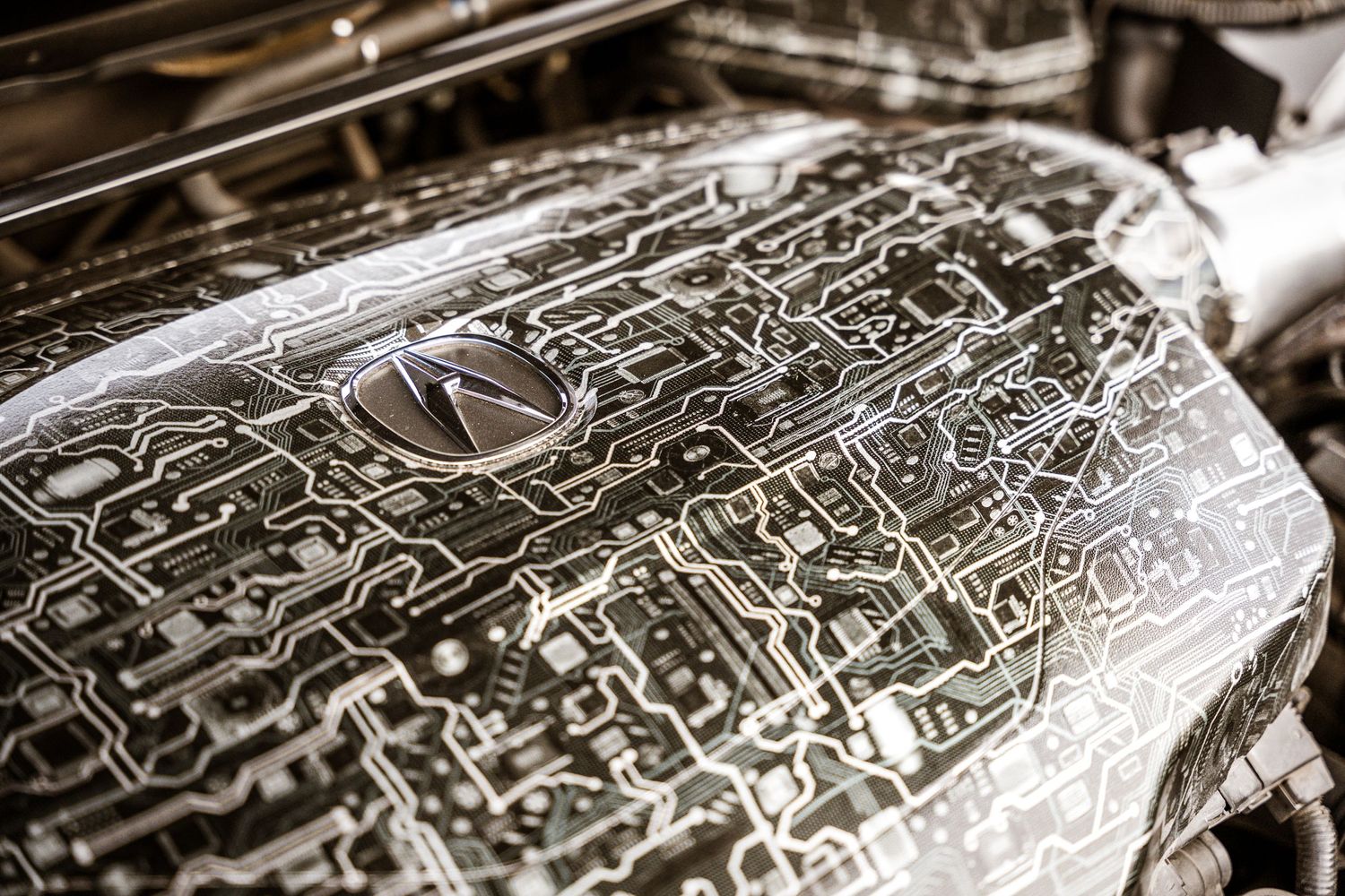 Detailed engine bay artwork showing intricate line drawings and mechanical patterns.