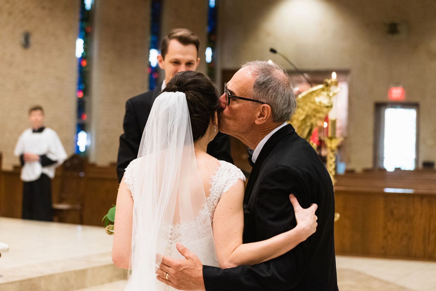 Intimate moment during wedding ceremony in church sanctuary.
