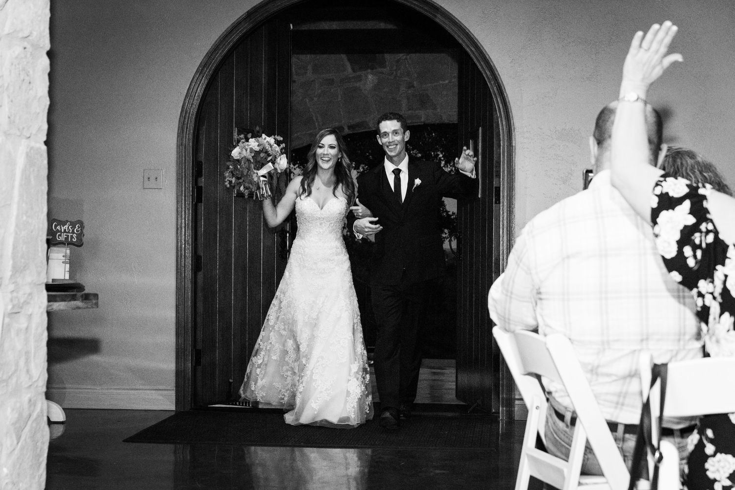 A grand entrance through an arched doorway during a wedding celebration.