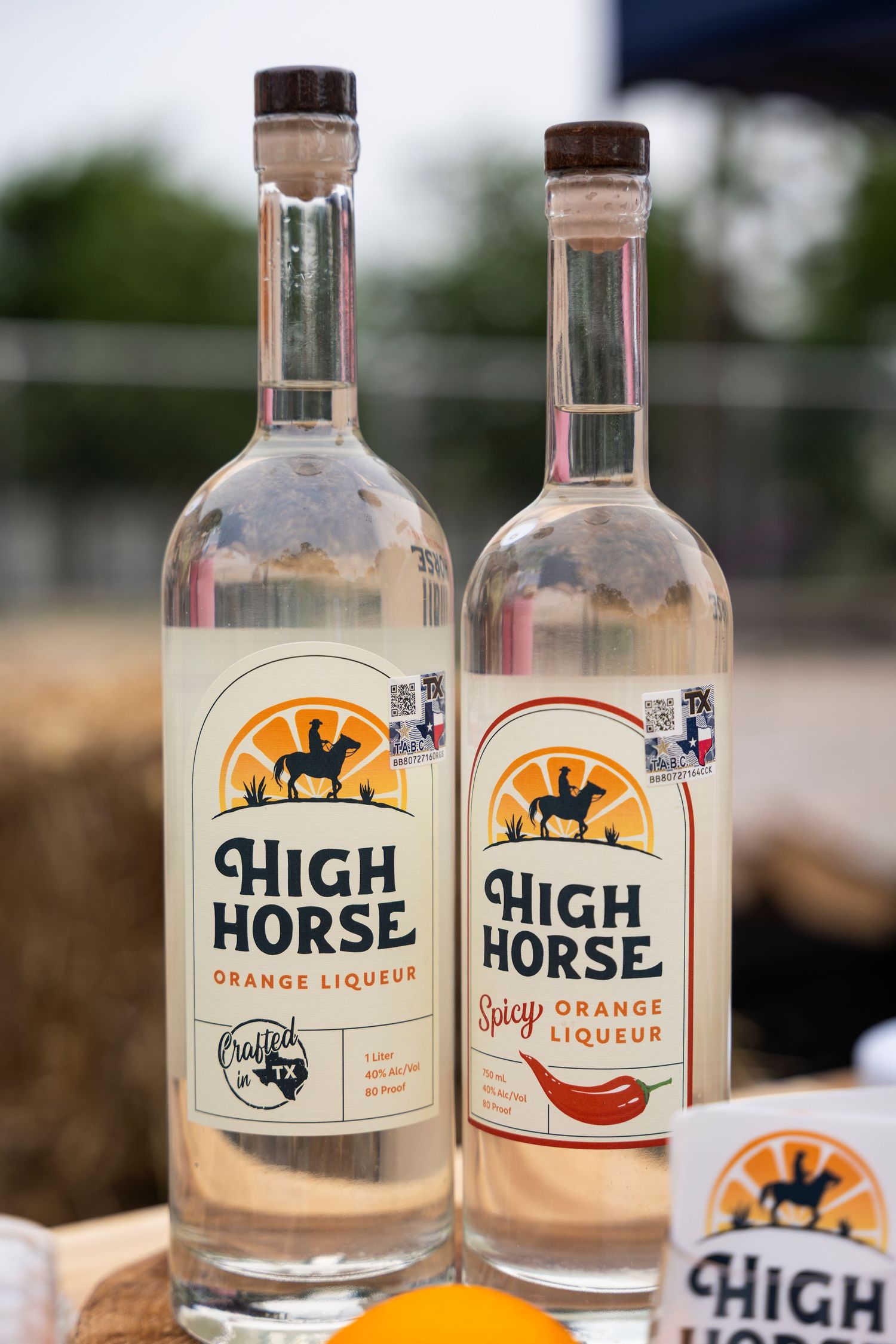 Bottles of High Horse branded liquor displayed on a wooden surface with blurred background.