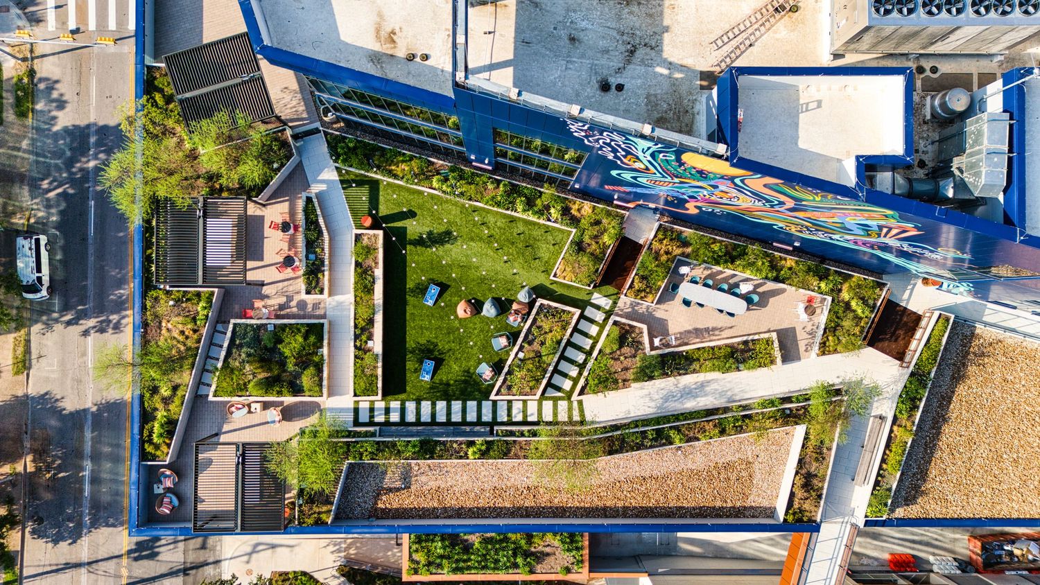 Aerial drone view of urban garden and residential development layout.