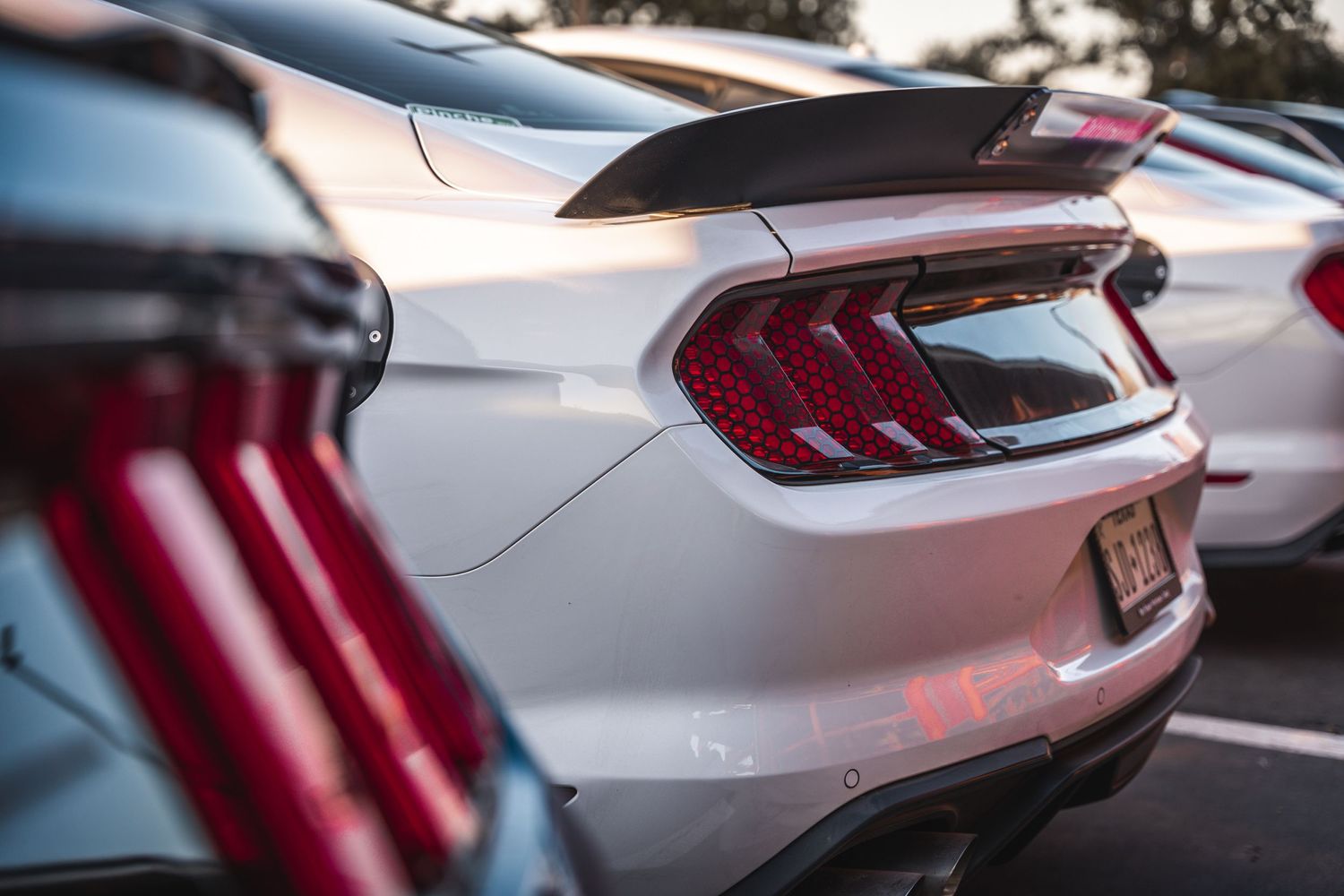 Close-up detail of modern Mustang tail lights and rear spoiler.