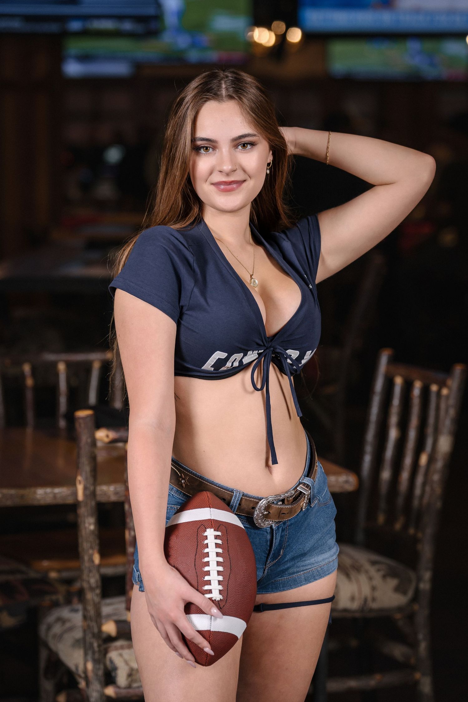 Sports bar promo shot featuring football and navy blue athletic wear.