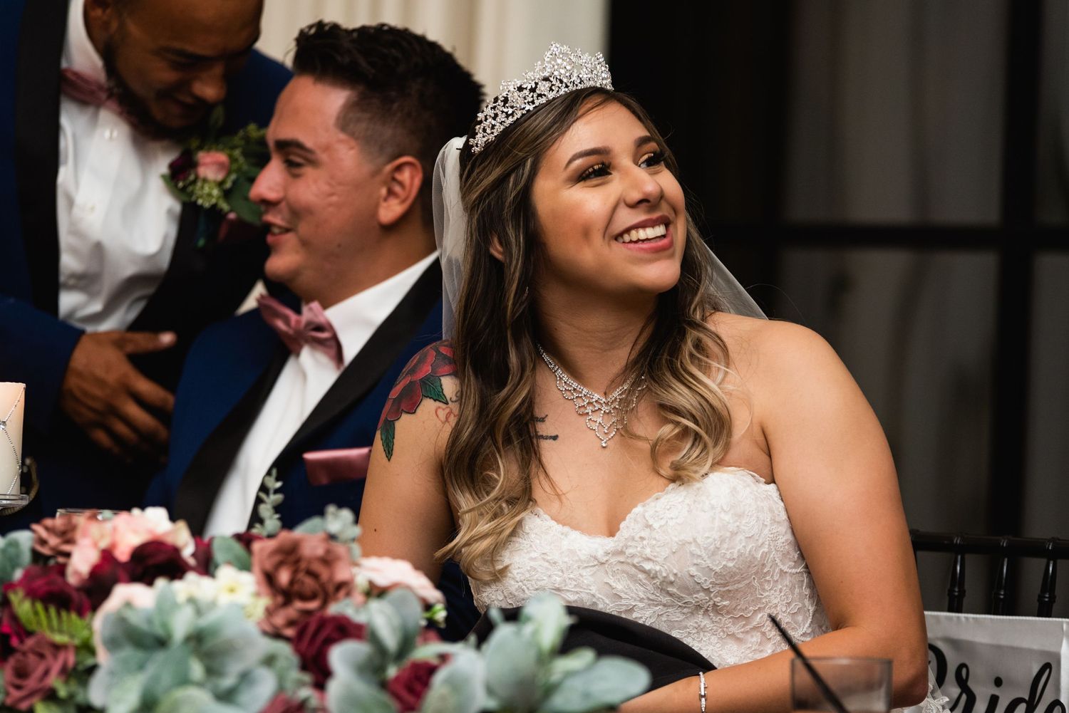 A special moment captured during wedding reception speeches at an elegantly decorated table.